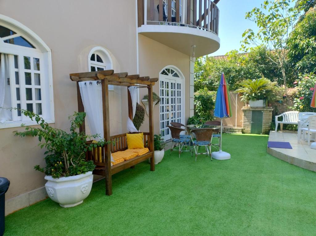 a patio with green grass and a swing at Casa da Oma in Penha