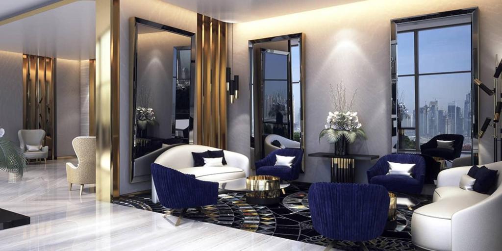 a rendering of a lobby with blue and white furniture at Luxury Hotel Apartment - DownTown in Dubai