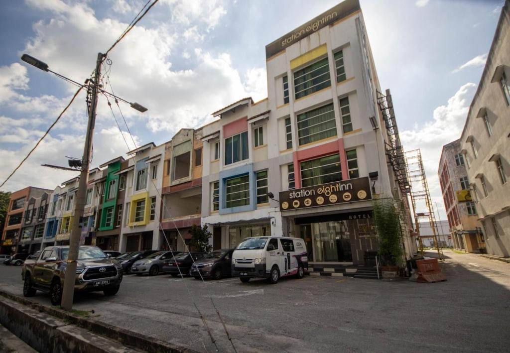 a street with cars parked in front of a building at JQ Station Eight Inn in Ipoh