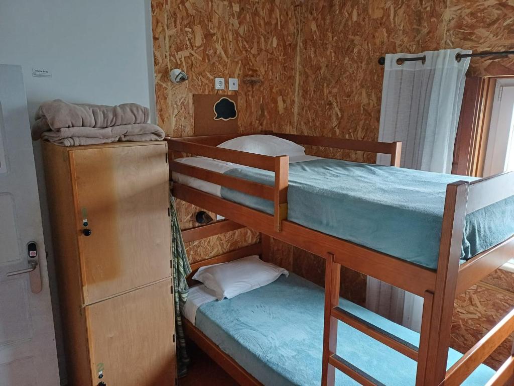 a couple of bunk beds in a room at Hostel Nature in Zambujeira do Mar