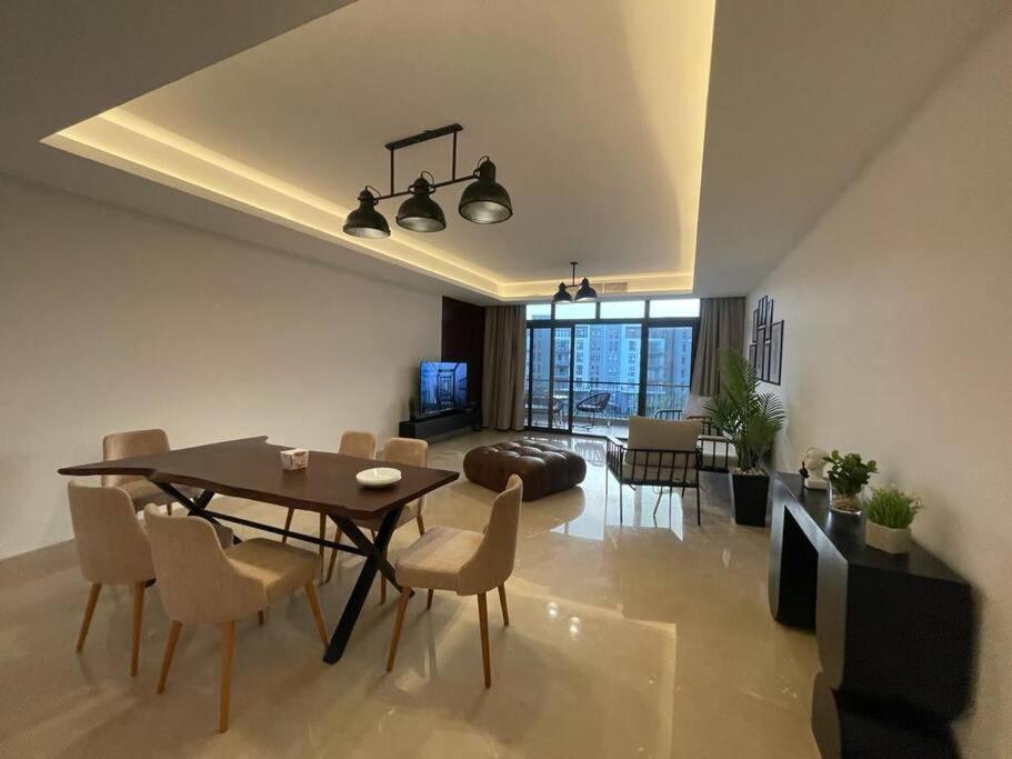 a dining room and living room with a table and chairs at Access - luxurious apartment at cfc in Cairo