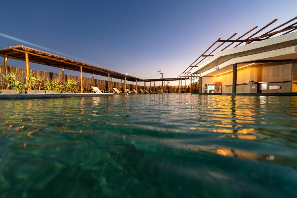 a swimming pool in front of a building at Nanii Hotel in São Miguel do Gostoso