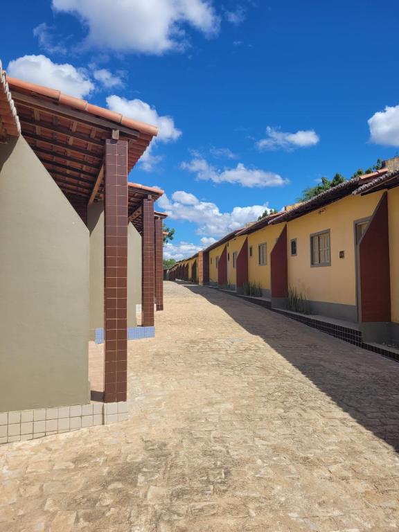 a row of buildings on a dirt road at Pousada Aquarela in Guamaré