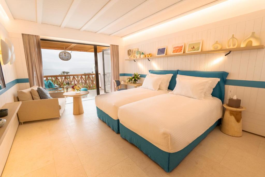 a bedroom with a bed and a view of the ocean at The View Agadir in Agadir
