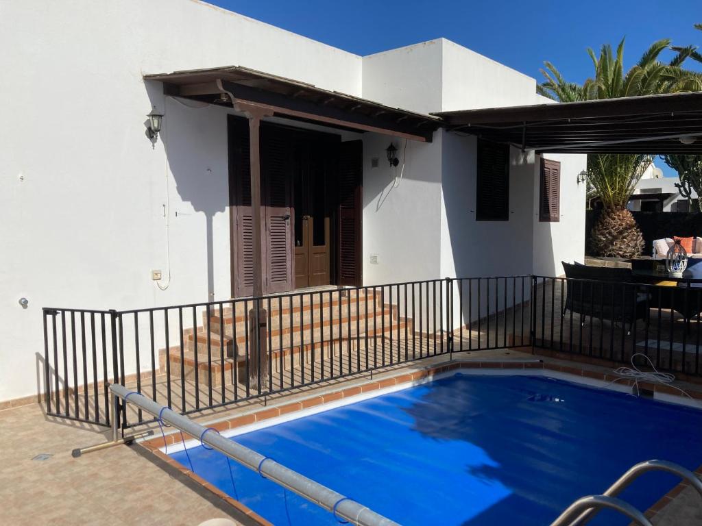 a swimming pool in front of a house at Mountain View Villa in Playa Blanca