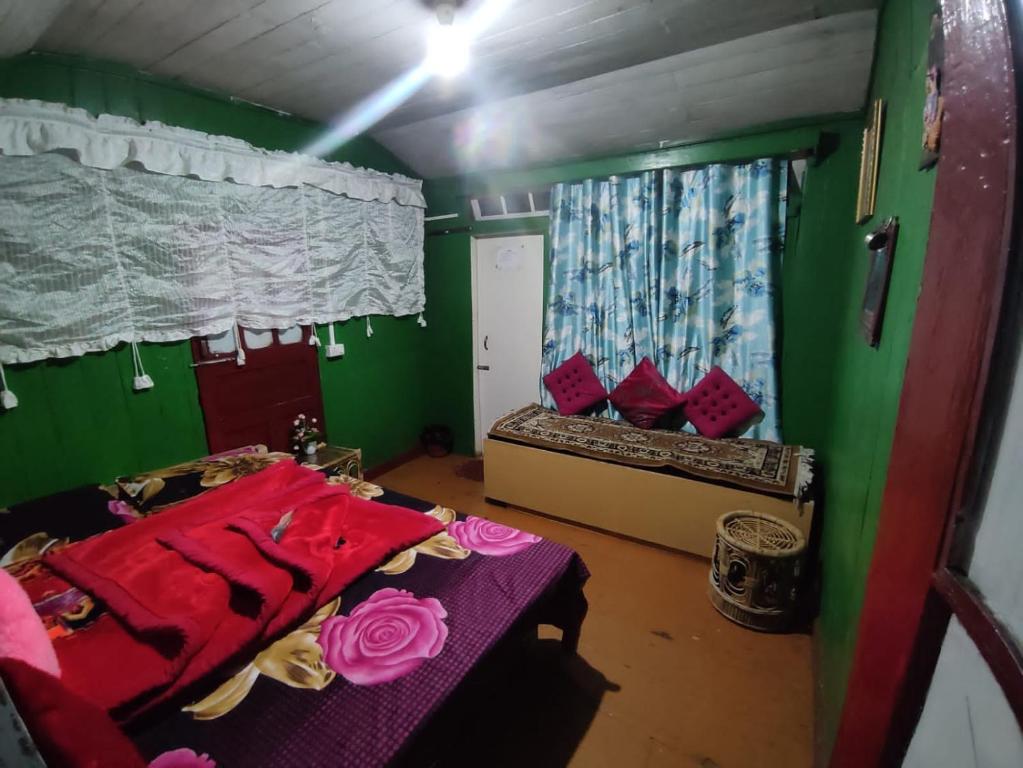 um pequeno quarto com 2 camas e uma janela em SHANTHI SAMAYA HOLIDAY HOMESTAY em Darjeeling