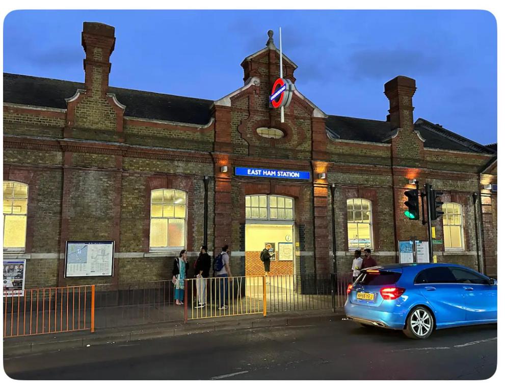 a blue car parked in front of a brick building at Reat Bungalow of 207A in London