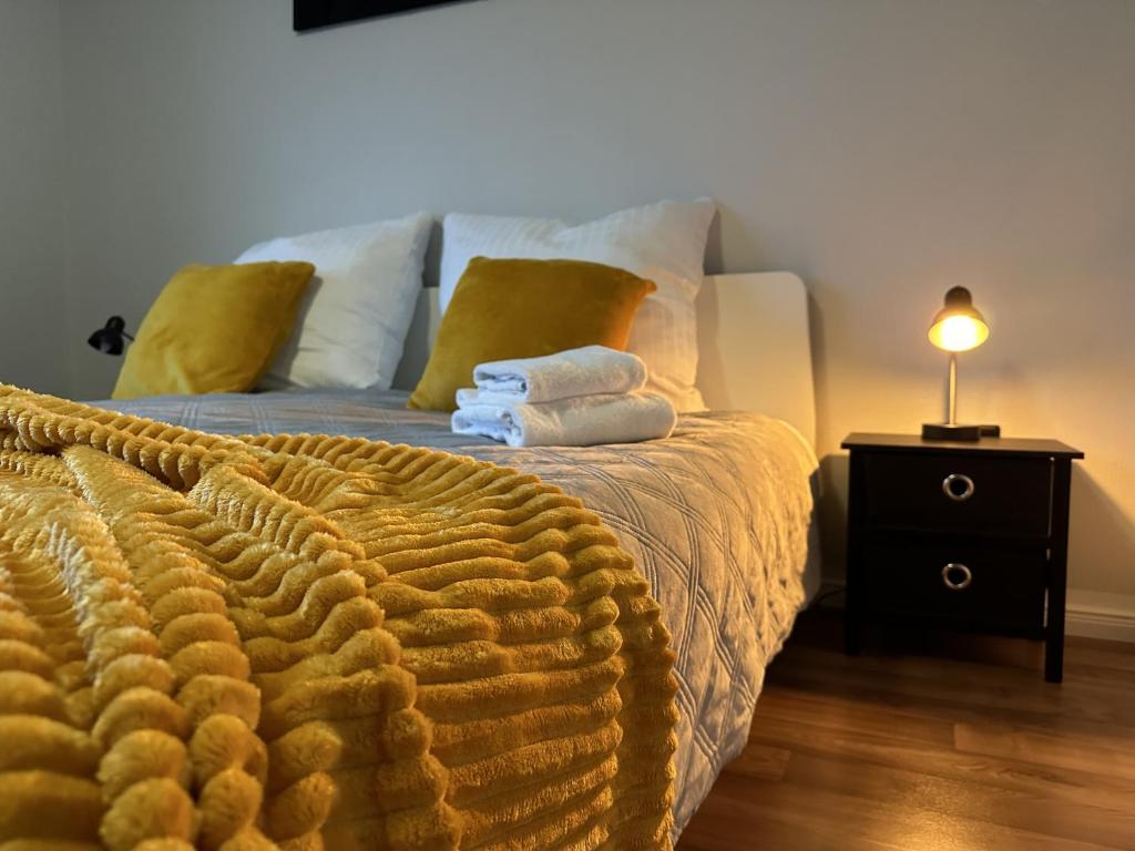 a bedroom with a bed with towels on it at Mid - Century in Schloß Holte-Stukenbrock