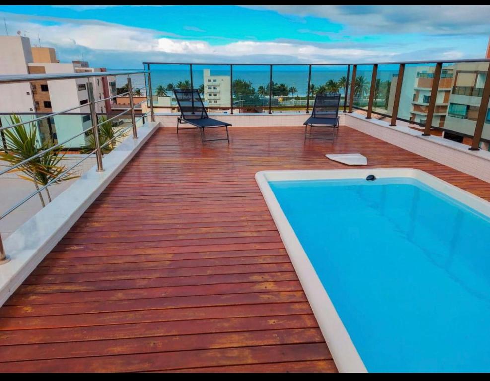 a balcony with a swimming pool on top of a building at Vista mare InterMares in Cabedelo