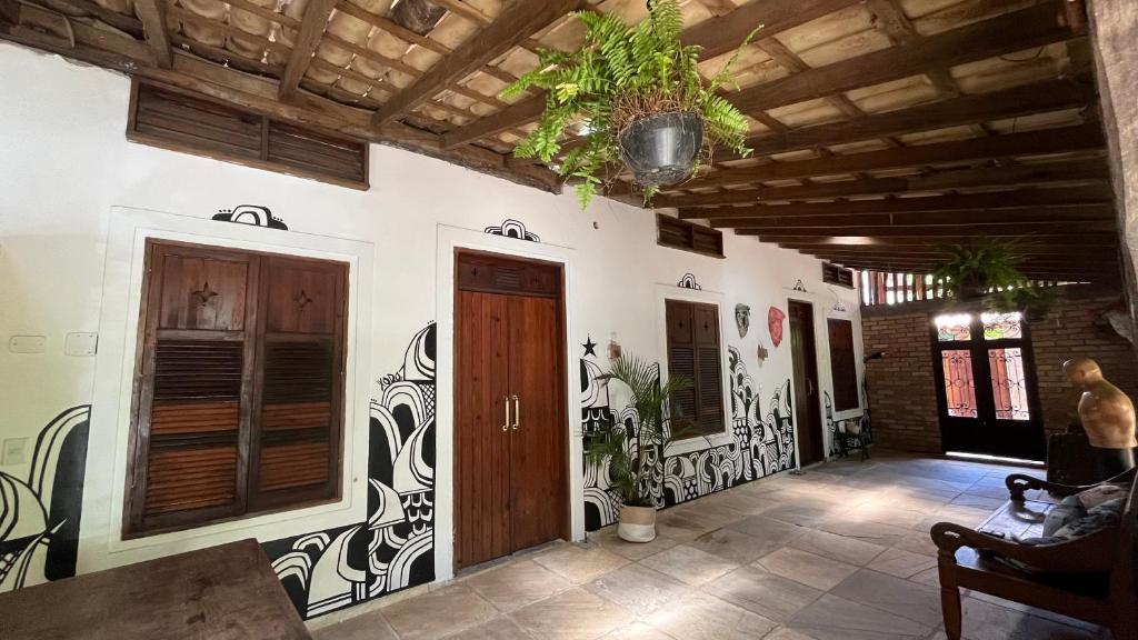 a hallway of a house with a wooden door at Mar & Ilha - Guest House - Praia de Maresias in São Sebastião
