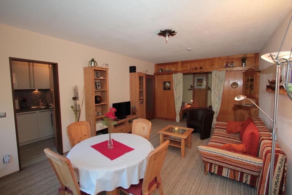 a living room with a table and a couch at FW Weissensee in Füssen