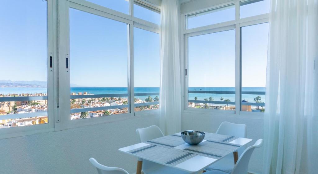 - une salle à manger avec une table et une vue sur la plage dans l'établissement Septimo Cielo Vistas al Mar Guadalmar, à Malaga