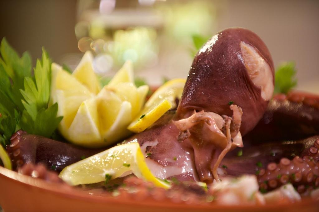 a bowl of food with meat and potato chips at Hotel Portonuovo in Vieste