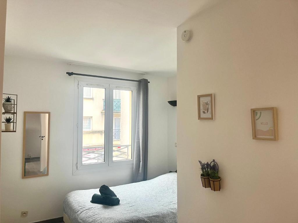 a bedroom with a bed and a window at Studio -SweetHome - Paris-Disney - 3 Min Gare in Bussy-Saint-Georges