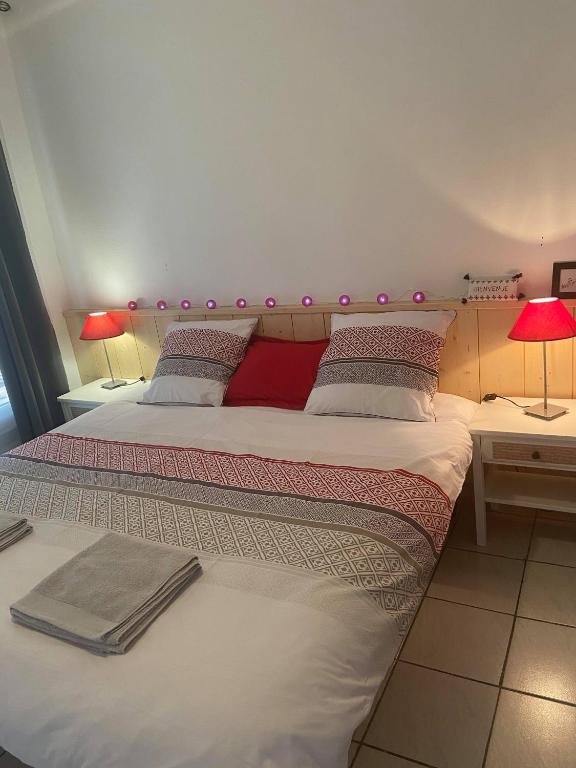 a bedroom with two beds and two tables with lamps at Les Gîtes d&#39;Angres - gîte n°1 in Angres