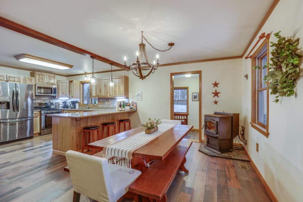 a kitchen with a wooden table and a dining room at Lovely Interlaken Home with Pool, Fire Pit and Yard! in Interlaken