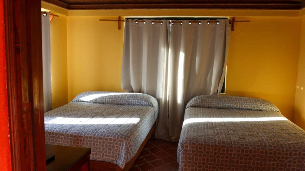 Postel nebo postele na pokoji v ubytování Posada La Mora - Hospedaje Panoramico