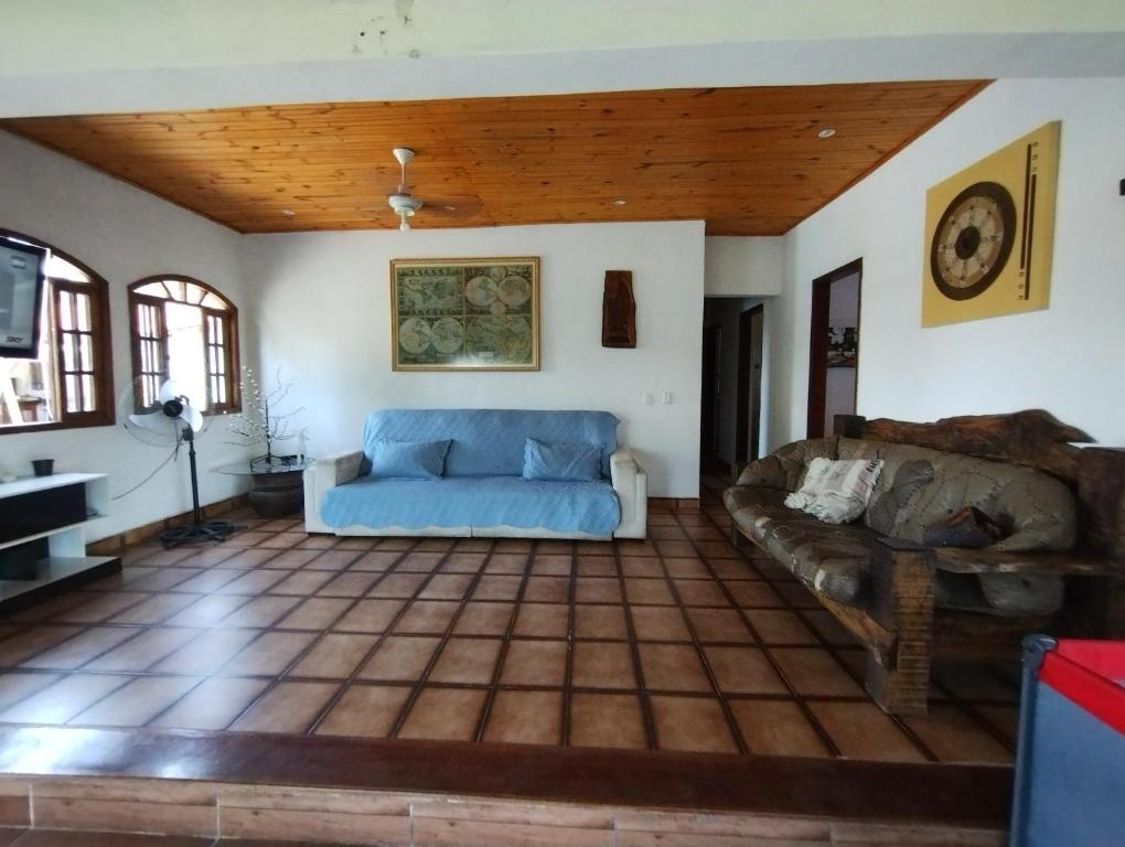 a living room with a couch and a table at Recanto Kamei-Piscina climatizada in São Roque