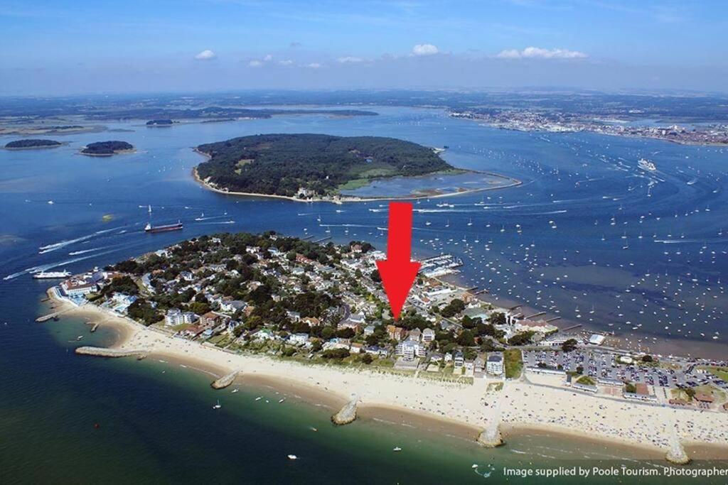 an island in the water with a red arrow at Superb Sandbanks Apartment near Beach and Bars with Free Parking in Poole