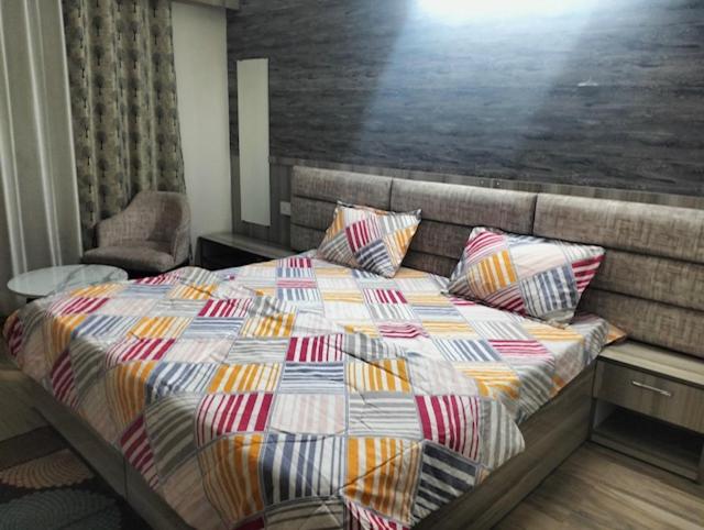 a bed with pillows on it in a bedroom at Hotel Moonlite in Greater Noida
