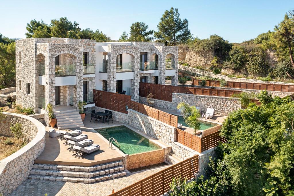 an exterior view of a house with a swimming pool at Seaesta Villas in Koskinou