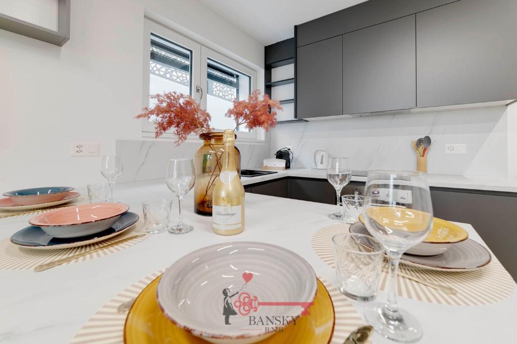 a kitchen with a table with plates and wine glasses at {Home Sofia} Room 2 - Modern Station in Lugano