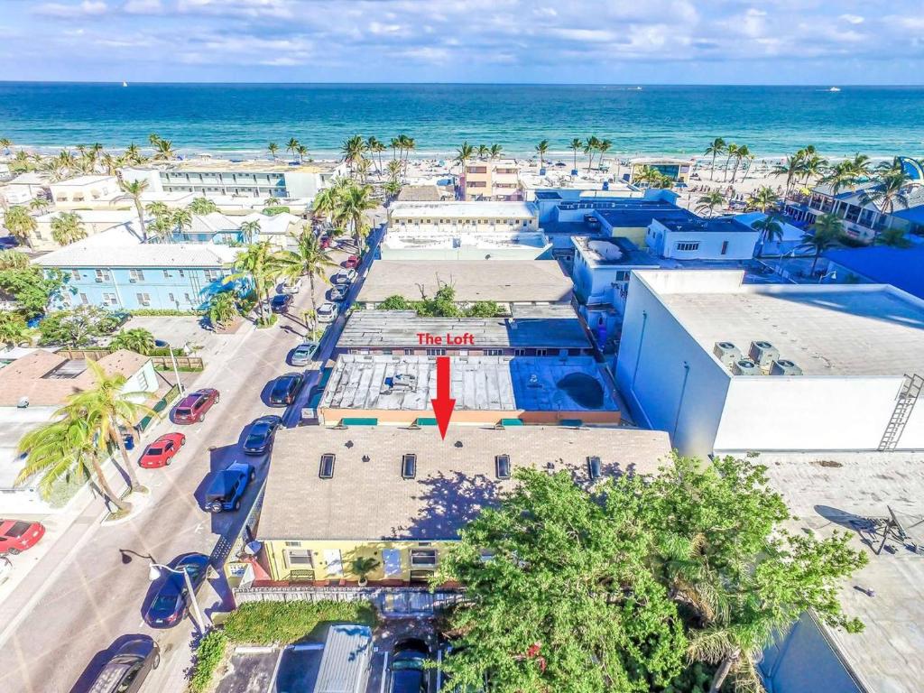 an aerial view of a beach with blue buildings and the ocean at amazing beach views love in Davie