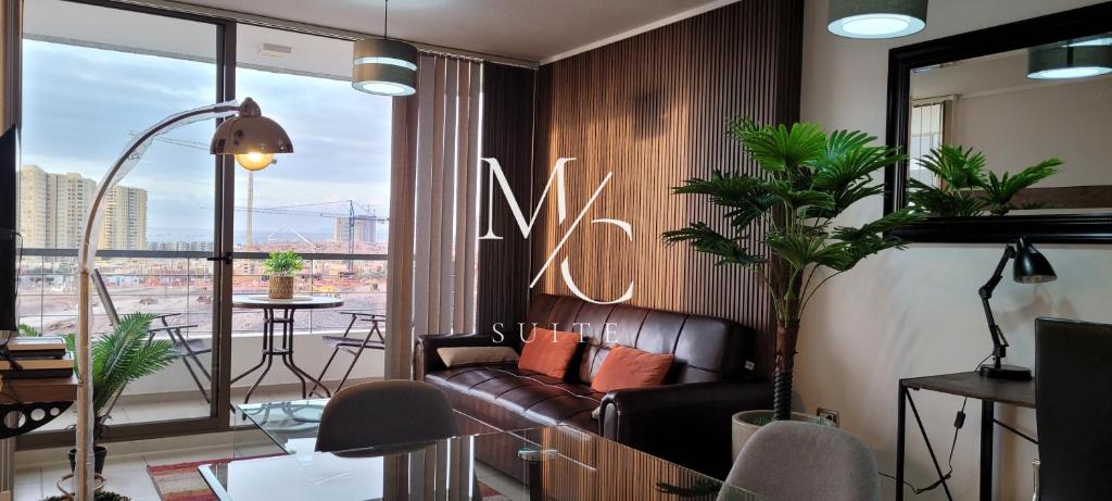 a living room with a couch and a large window at MC Suite Norte - Vista al mar in Antofagasta