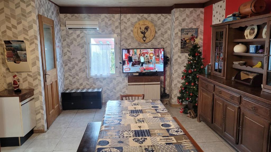 a kitchen with a table and a christmas tree at maison de vacances FRECONRUPT in La Broque