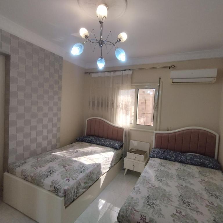 Postel nebo postele na pokoji v ubytování Apartment Nasr City