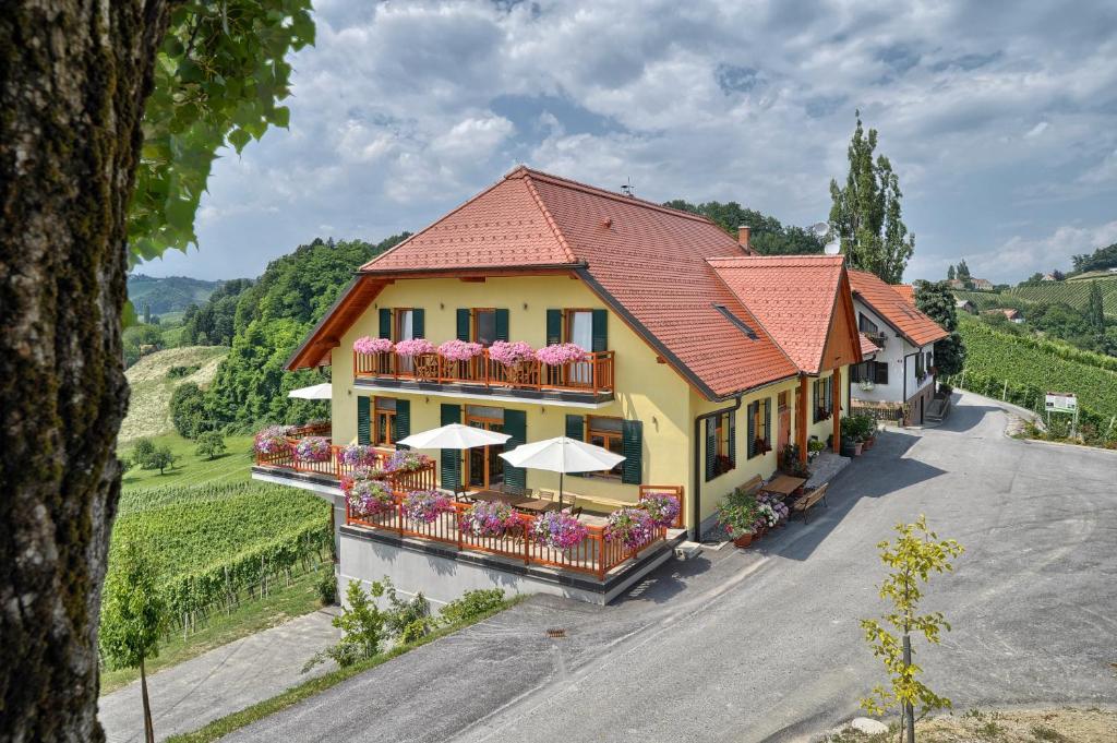 an aerial view of a building with flowers and umbrellas at Farm Stay Jarc Vineyard in Svečina