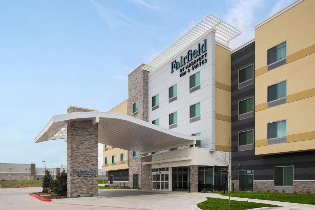 a hotel with a sign on the front of it at Fairfield by Marriott Inn & Suites Dallas McKinney in McKinney