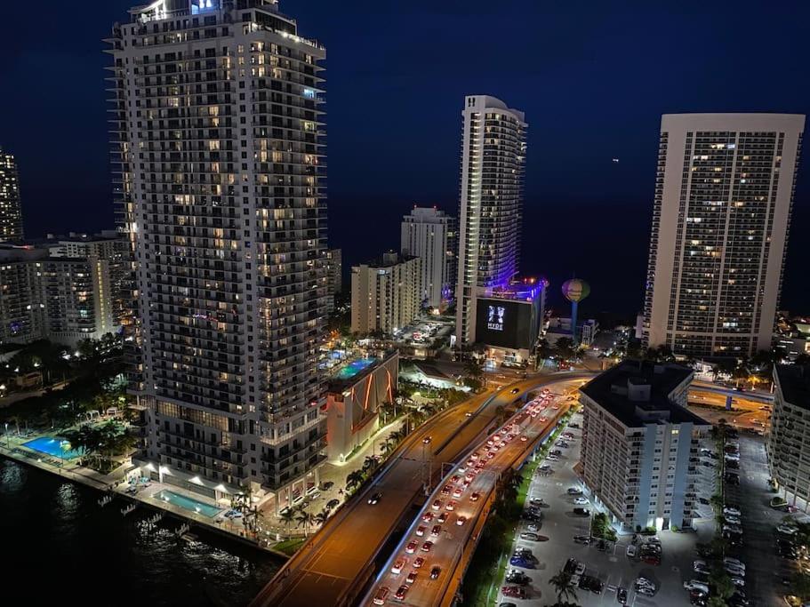 a city skyline with tall buildings and traffic at night at Smart Stay Near the Ocean 2Full Beds Beach Studio in Hallandale Beach