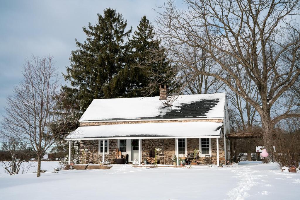 a house with snow on the roof at Turtle Stop Farm - Historic Farmhouse in Upper Black Eddy