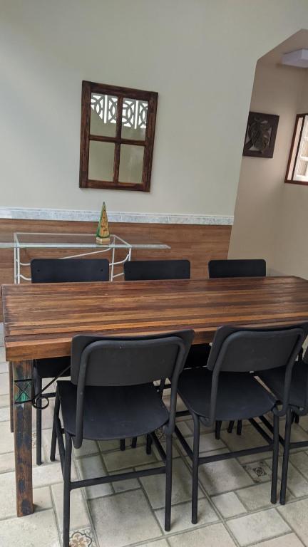 a large wooden table with chairs in a room at Casa de praia in Guarapari