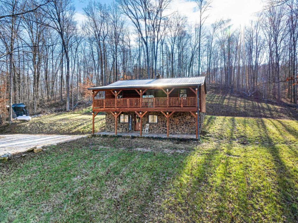 a house with a deck in the middle of a field at Serene Tell City Retreat Near Hiking and Skiing! in Tell City