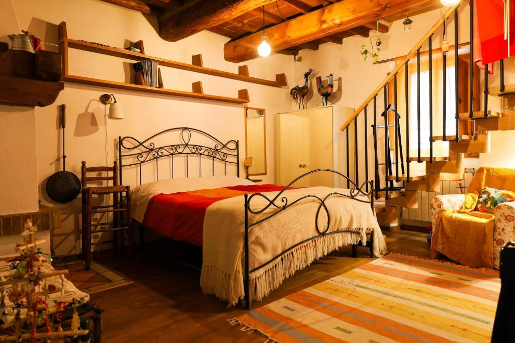 a bedroom with a bed in a room with a staircase at I Rosai appartamento sulle colline fiorentine in Bagno a Ripoli