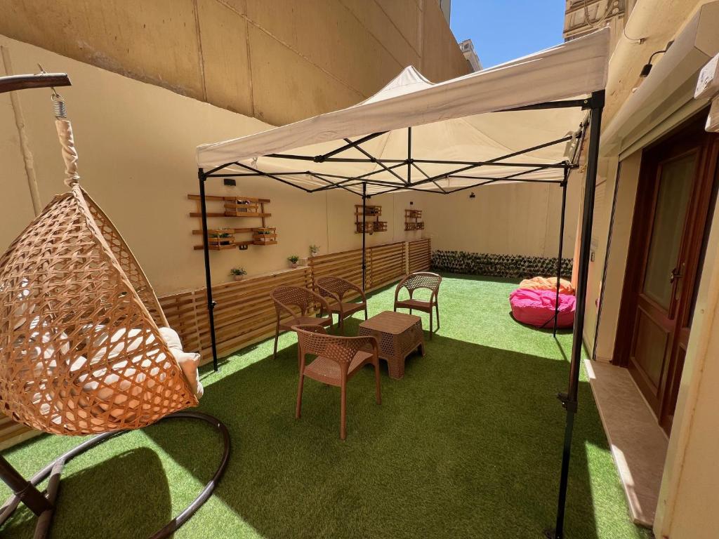 a patio with a hammock and a swing at Charming 2BR with Private Garden in Cairo