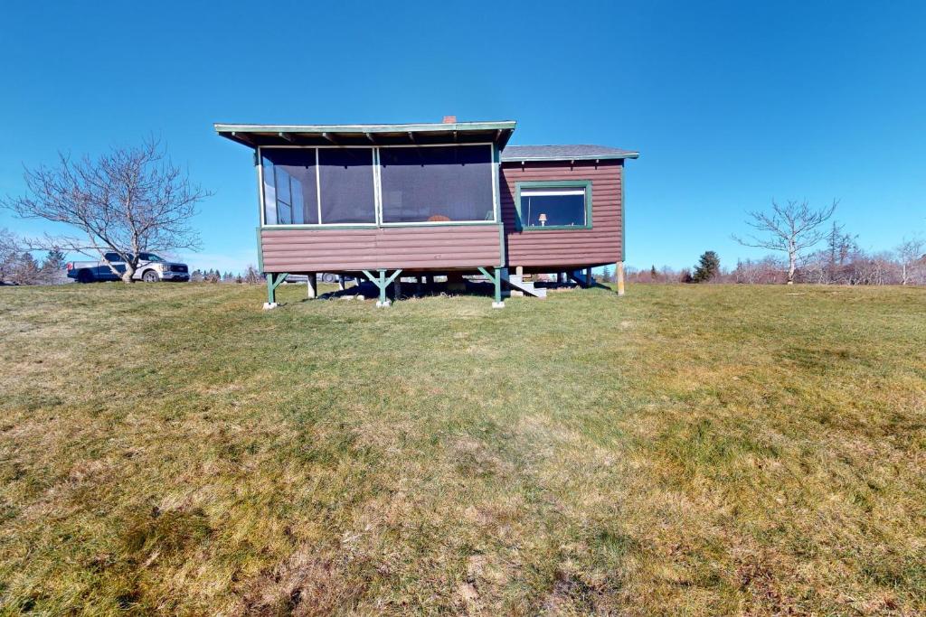 a tiny house on a grassy field at Castine Cottages # 4 in Castine