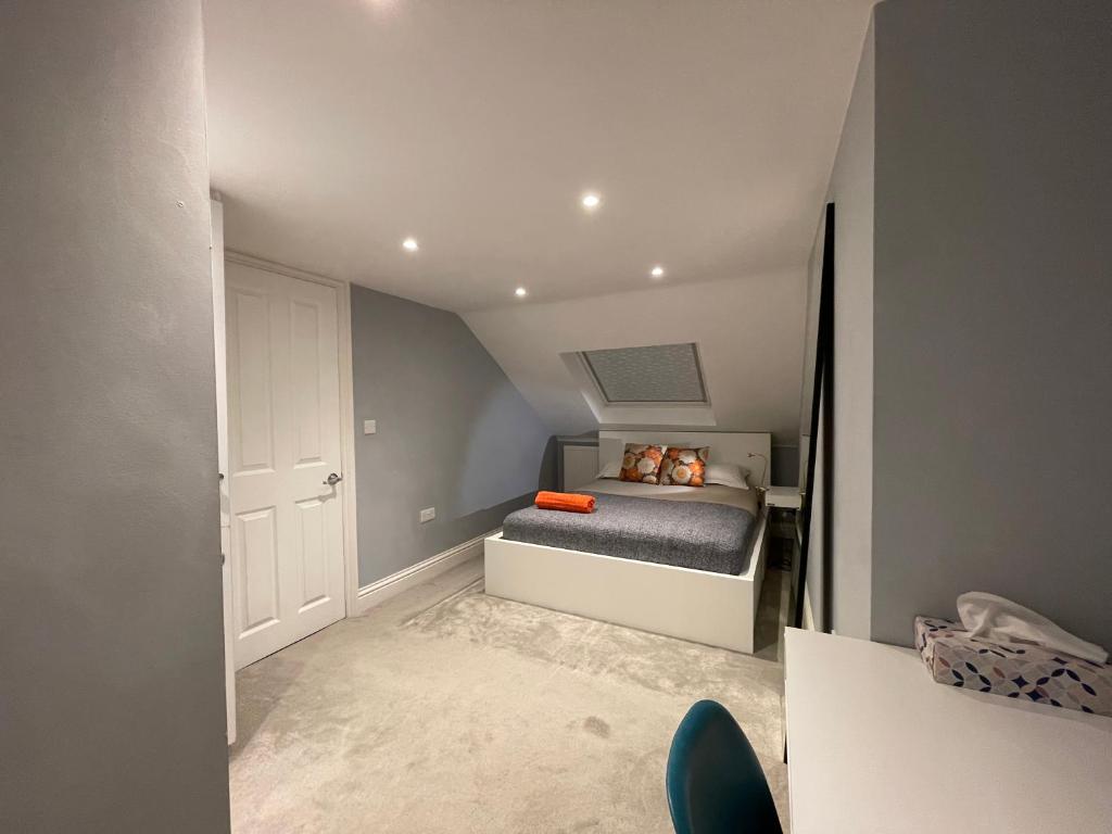 a small bedroom with a bed in a attic at Home in Greenwich near the O2 in London