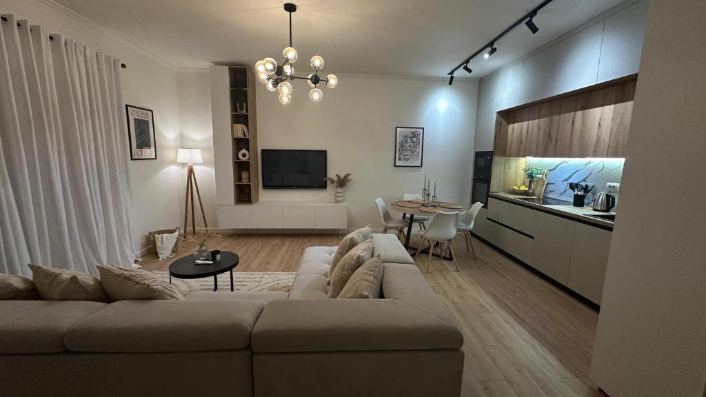 a living room with a couch and a table at Gjirokastra Design Apartments in Gjirokastër