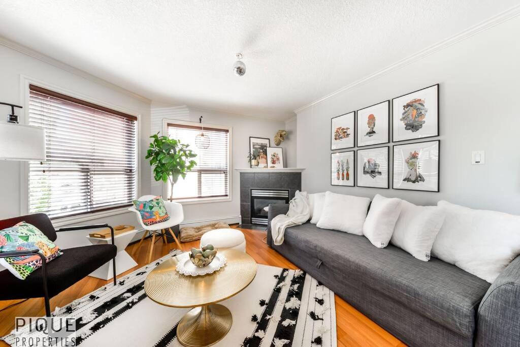 a living room with a couch and a table at The Breakfast Club Suite - King Bed & AC - Patio - UG Park in Edmonton