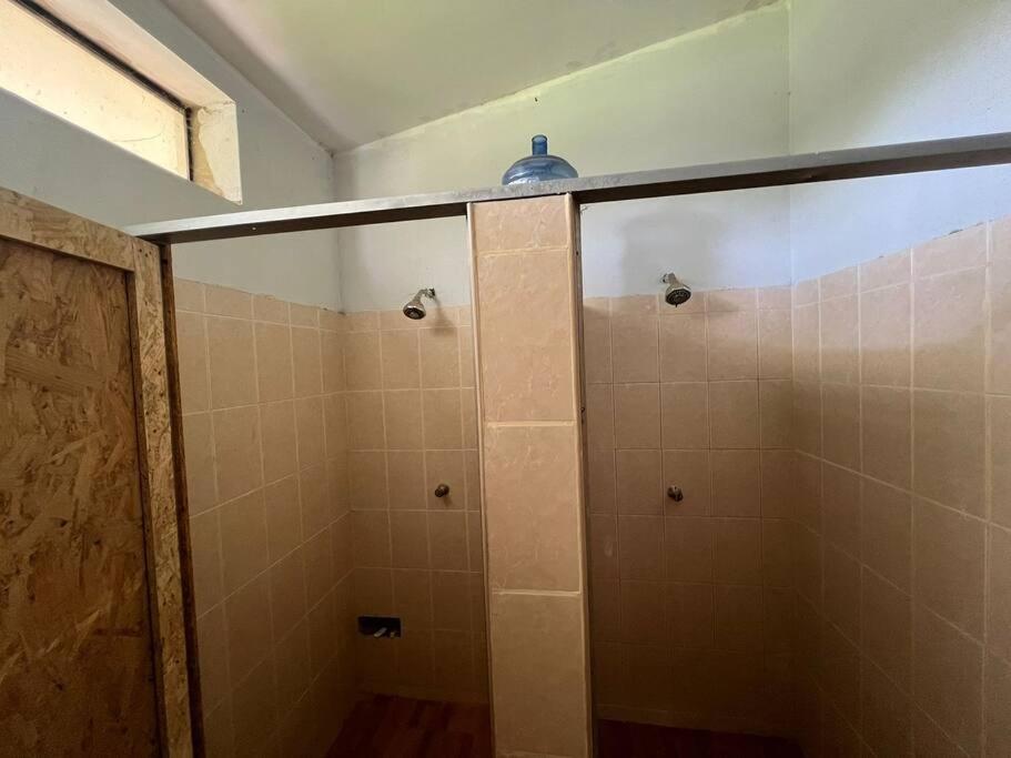 a bathroom with a shower with a glass door at Casa de Campo en Conache in Trujillo