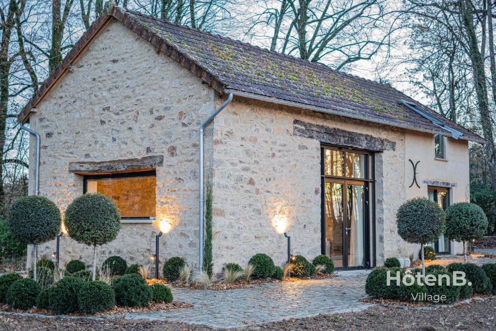 a stone building with lights in front of it at The Louis Aragon Cottage Exceptional Elegance in Nexon