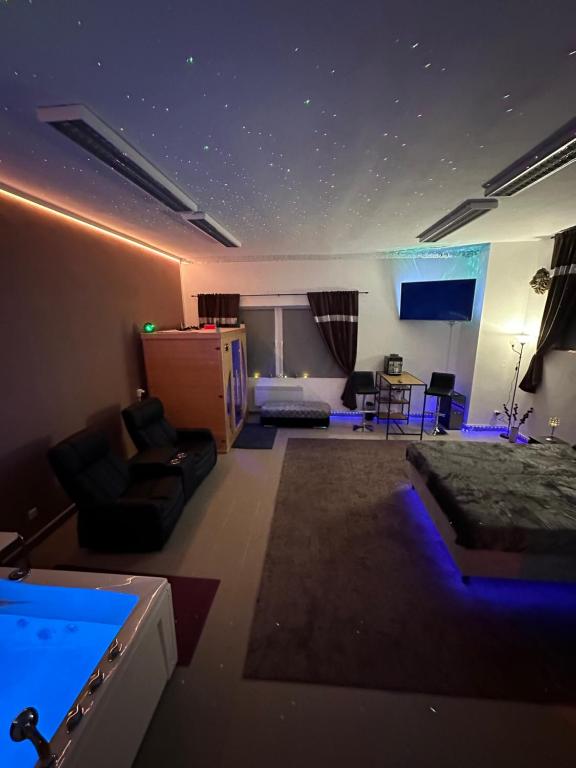 a room with a living room with blue lights at Relax studio Cheb in Cheb