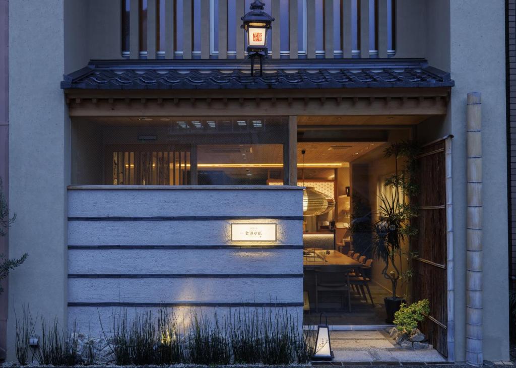 a house with a light on the front of it at Hotel Kanazawa Zoushi in Kanazawa