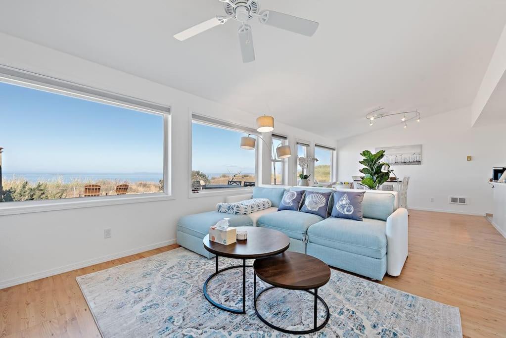 a living room with a blue couch and a table at West Beach Point BY Betterstay in Oak Harbor