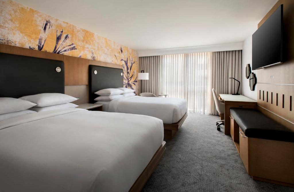 a hotel room with two beds and a television at Westchester Marriott in Tarrytown