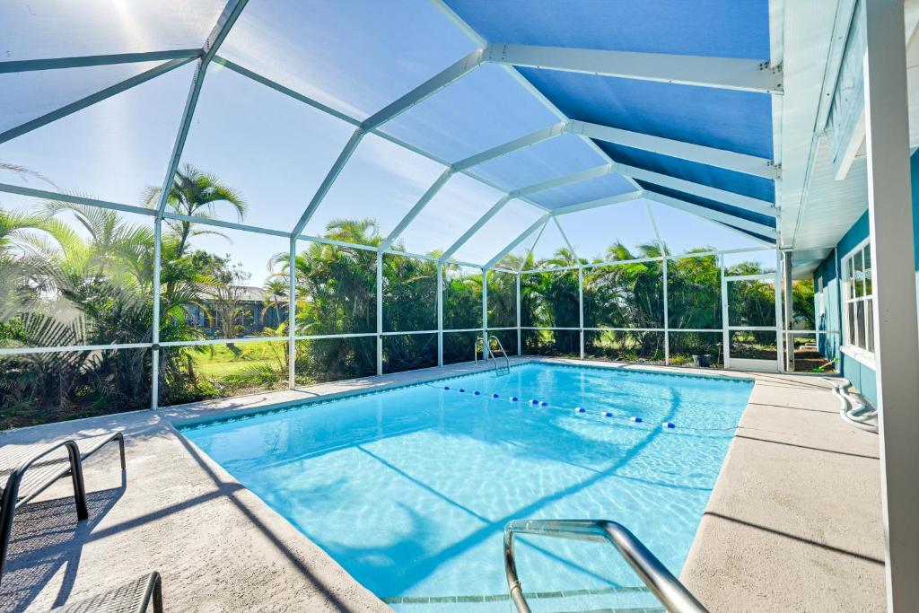 an indoor swimming pool with a large glass ceiling at Florida Gulf Coast Getaway Pool and Screened Lanai! in Rotonda West