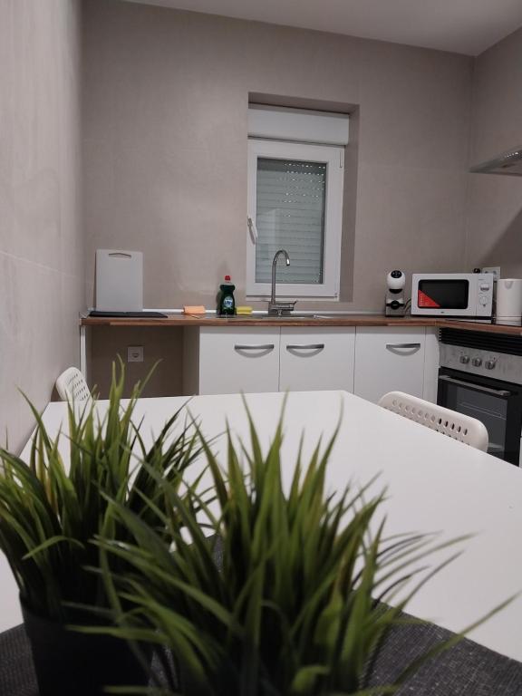 a kitchen with a white table and a sink at Apartamento Gran Turia in Valencia